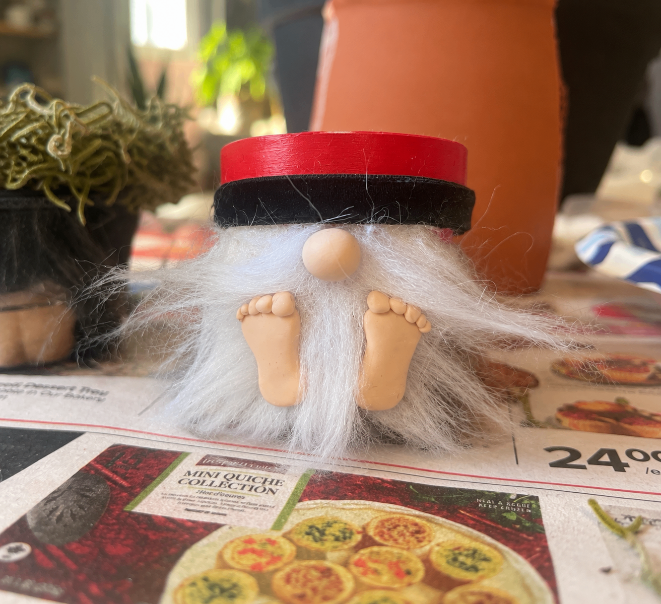Mini gnome with a red hat, fluffy white beard and little clay feet